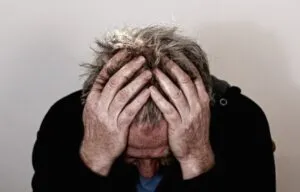 man with head in hands